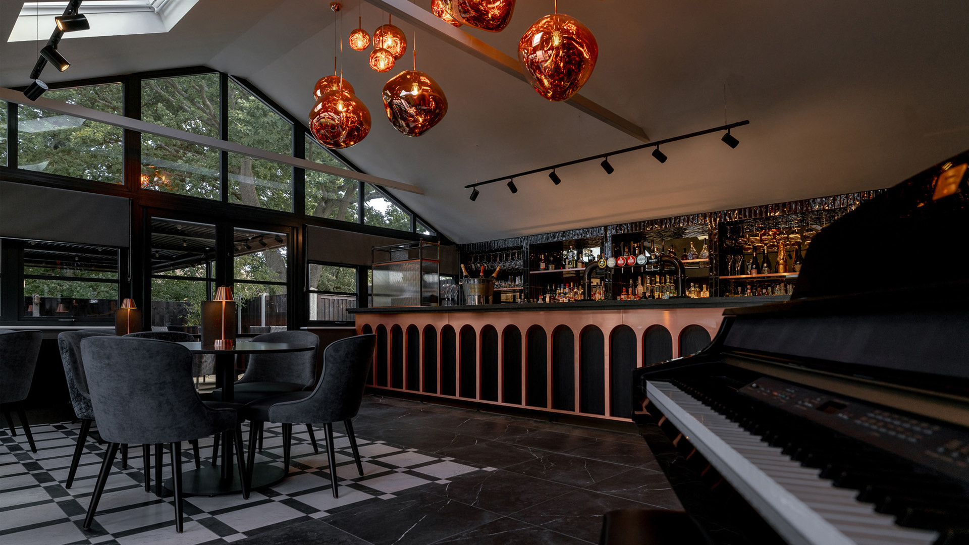 Large windows in the bar area with the piano