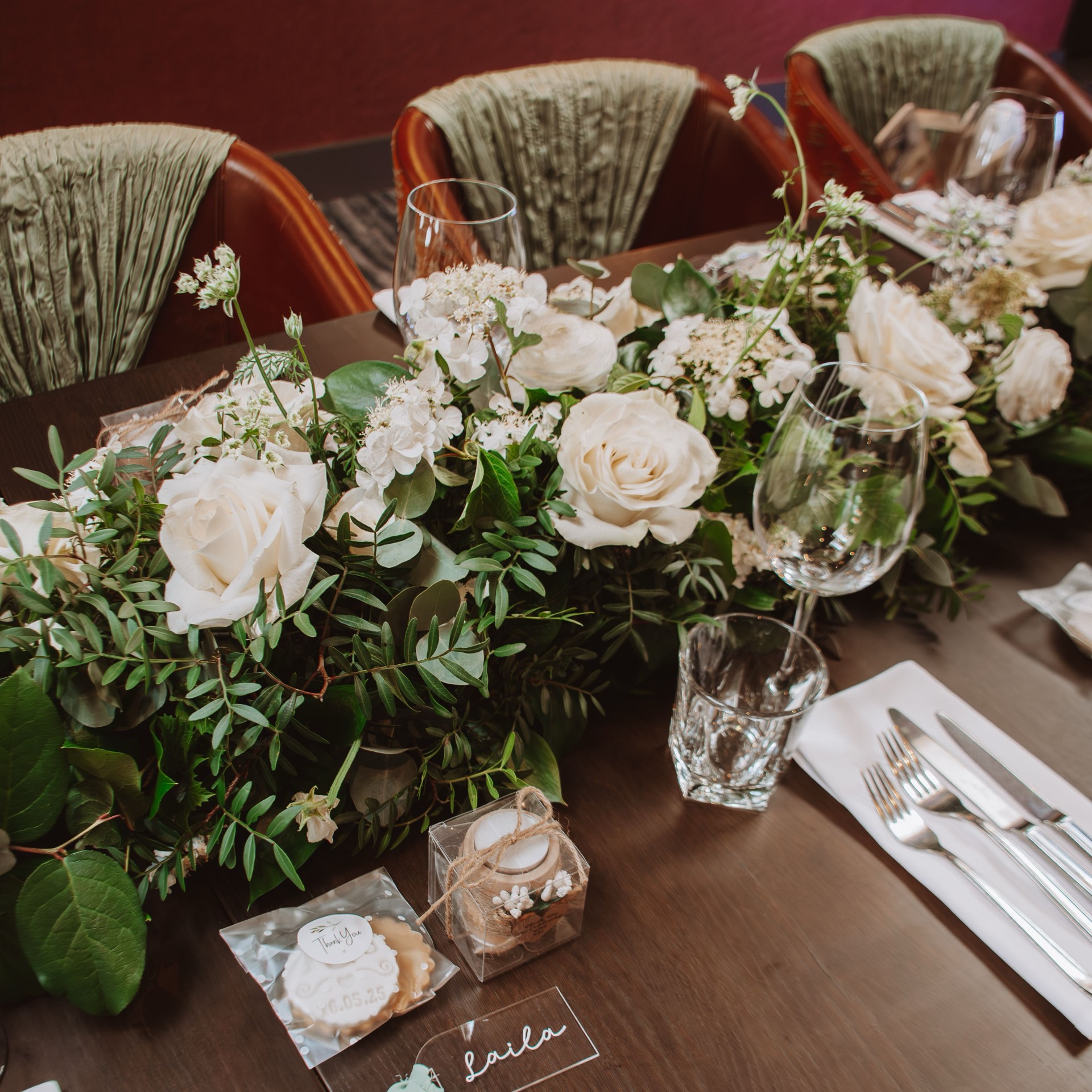 White roses and greenery dressing a wedding table at Mason's