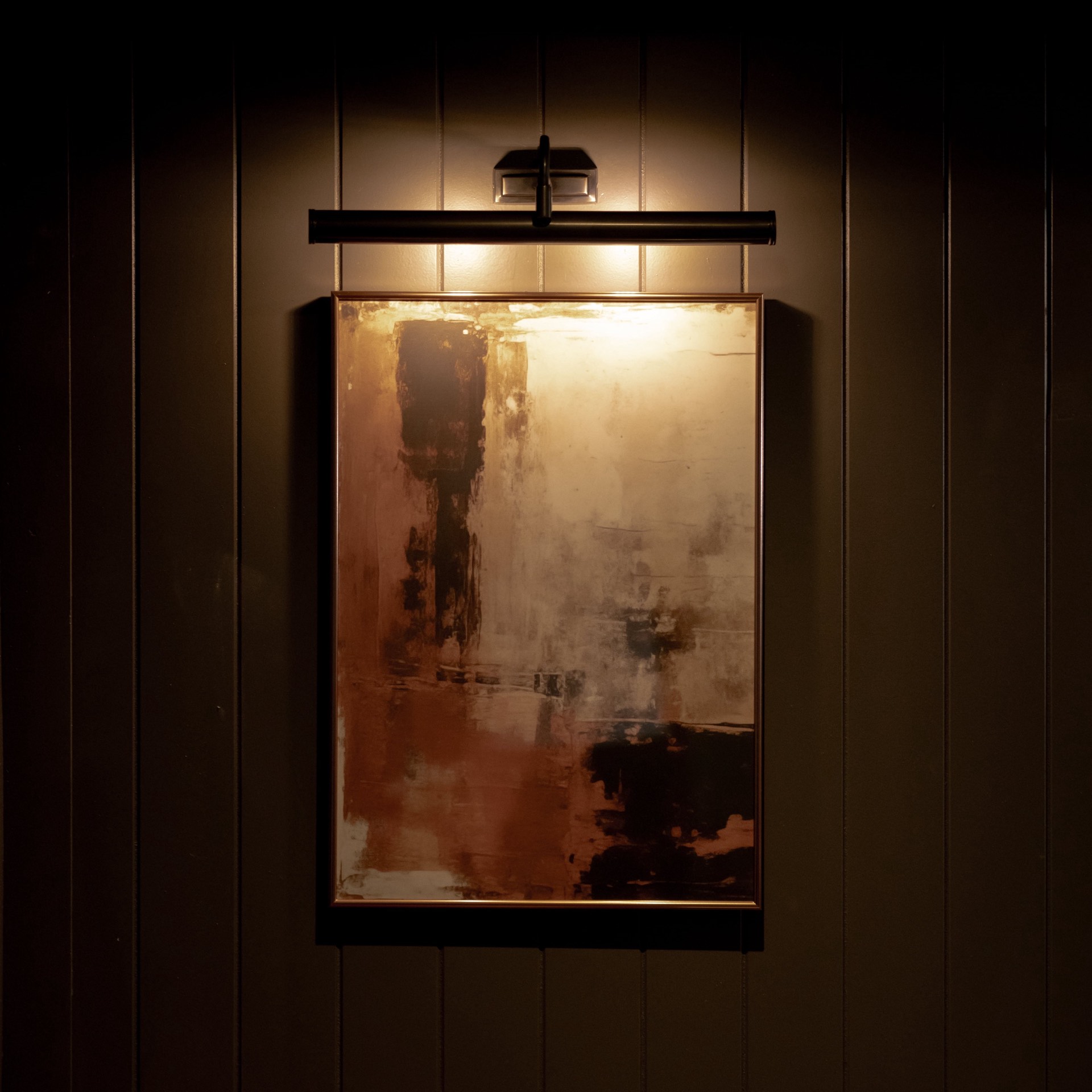 An artwork lit by a picture light on the panelled wall at Mason's