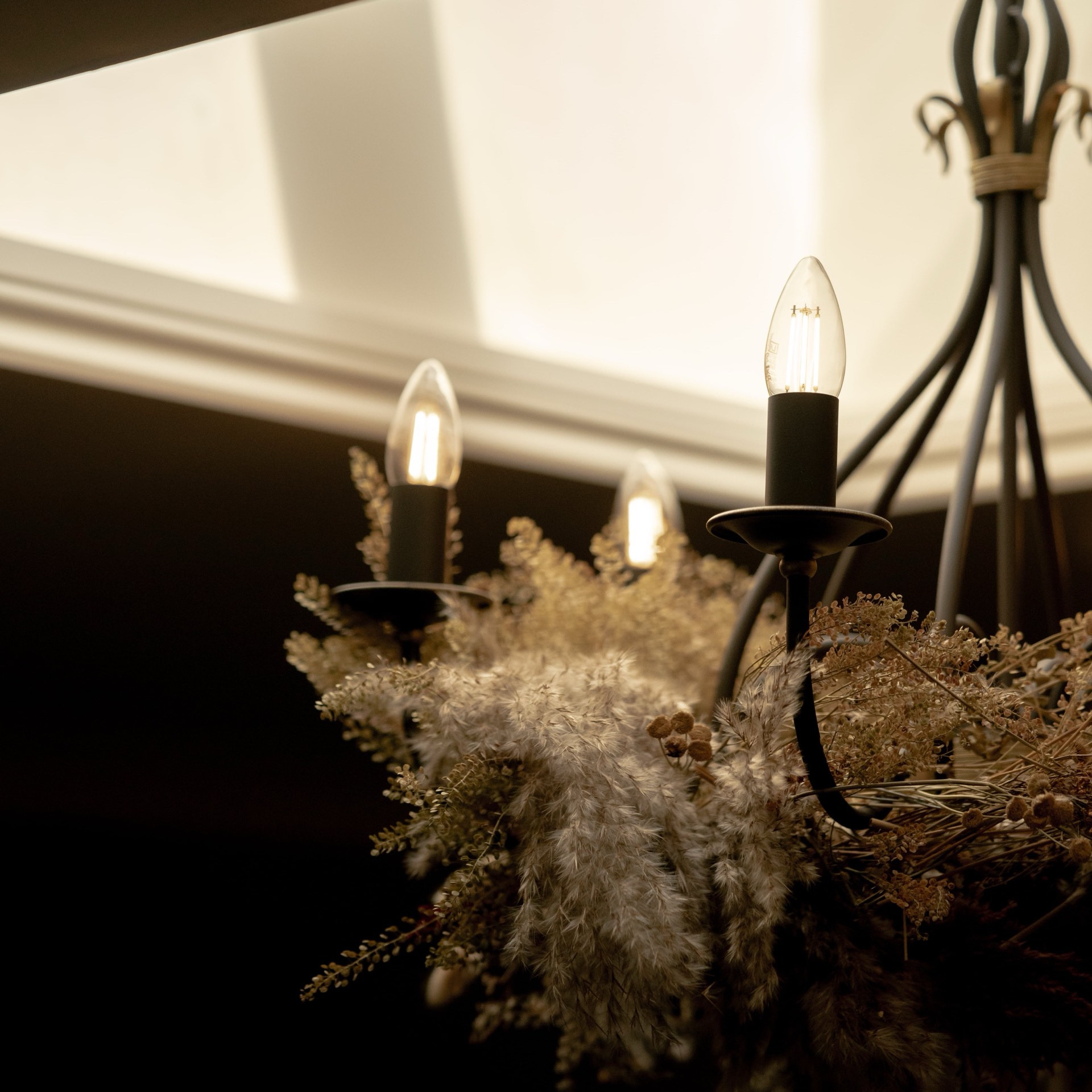 Dried flowers hanging beneath the chandelier at Mason's