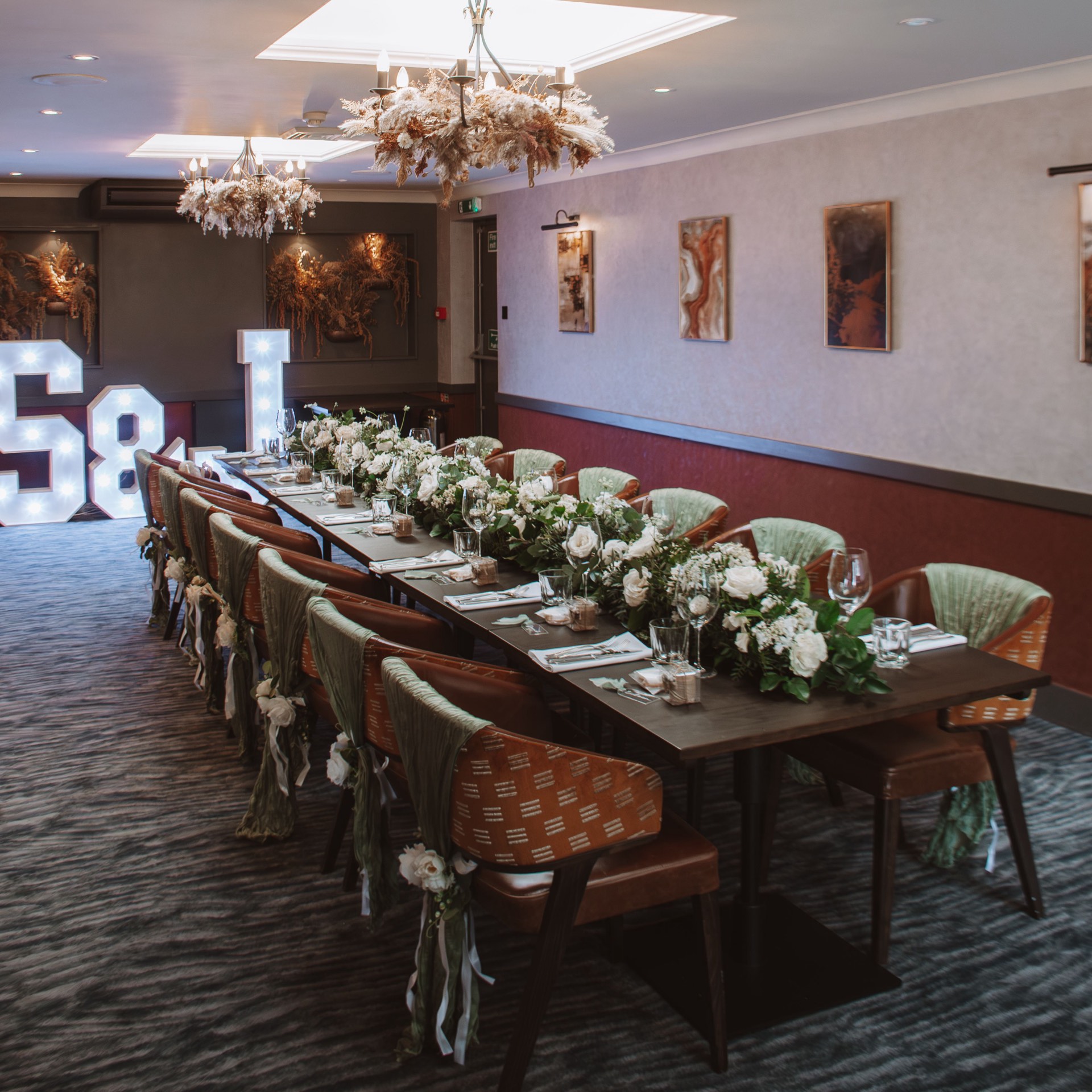 A long wedding table set with flowers at Mason's