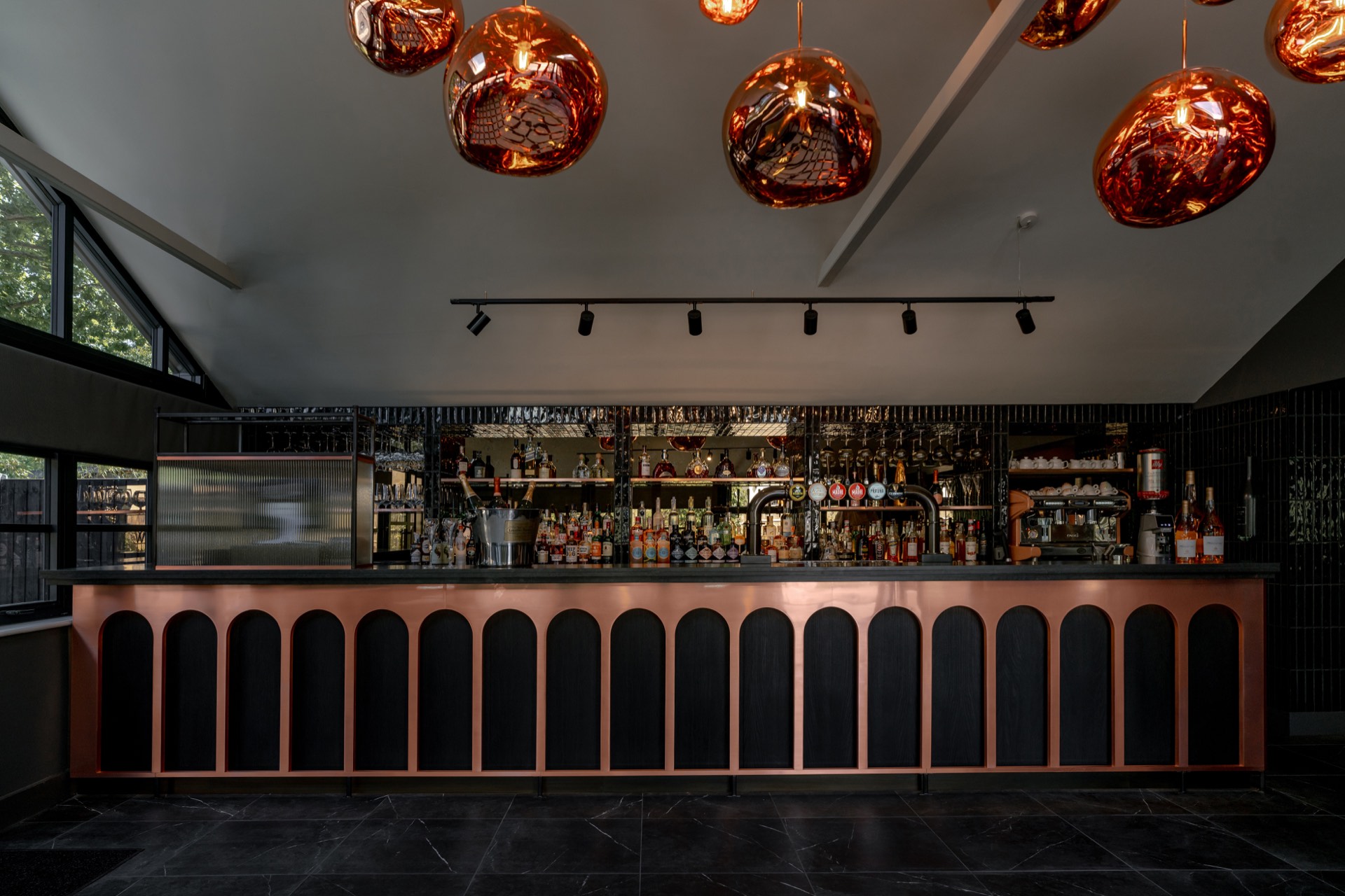 The copper-fronted bar at Mason's beneath its amber pendant lights